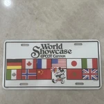 1990 Disney World Showcase Epcot Center Mickey Mouse Booster License Plate. Fixed Price $40.00.