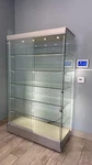 Glass Display Cabinet 5-SHELF 2 Sliding Doors W/light Product/trophy Case. Fixed Price $1875.00.